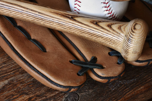 A close up image of old used baseball equipment. - Фото, зображення