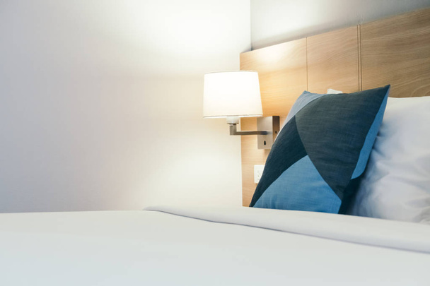 Comfortable white pillow on bed decoration in hotel bedroom interior - Fotoğraf, Görsel