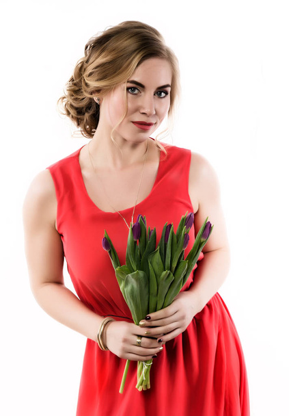 beautiful woman with flowers tulips on a light background - Fotoğraf, Görsel