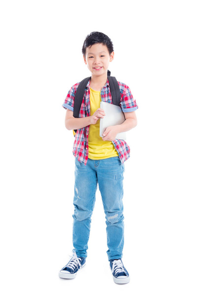 Full length of young asian schoolboy  standing and smiling  - 写真・画像