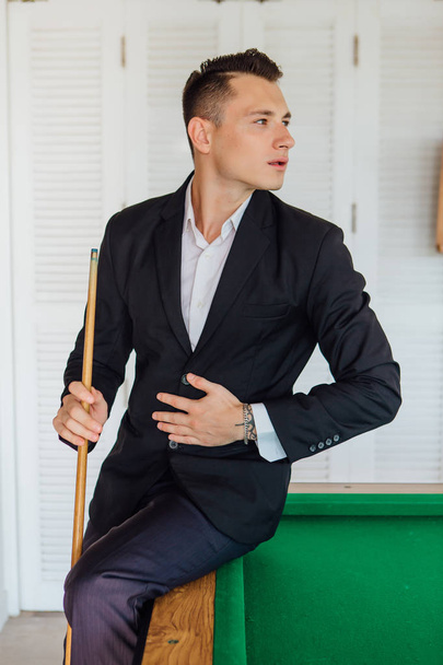 Young handsome man playing billiard game alone - 写真・画像