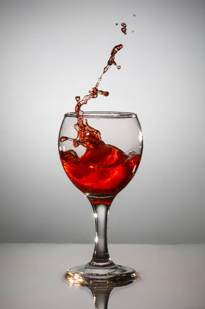 wine in a glass on a gray background - Zdjęcie, obraz