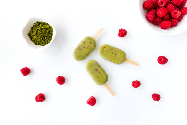 Three Matcha and Raspberry Popsicles on White Background   - Foto, imagen