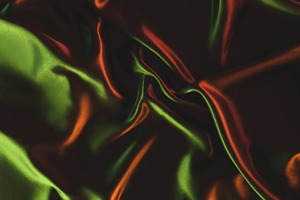 close up view of dark green crumpled silk cloth as backdrop - Photo, Image