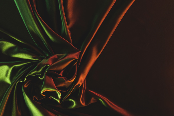 close up view of dark green crumpled silk cloth as backdrop - Photo, Image