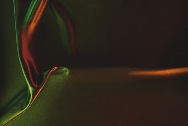 close up view of dark green crumpled silk cloth as backdrop - Fotografie, Obrázek