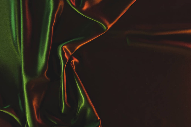 close up view of dark green crumpled silk cloth as backdrop - Photo, image