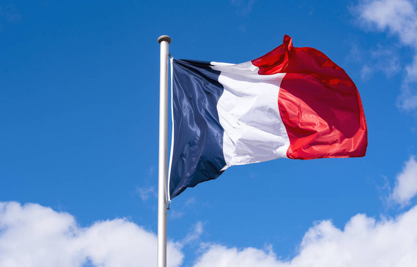 French Flag waving against blue Sky during sunny Day in France - 写真・画像