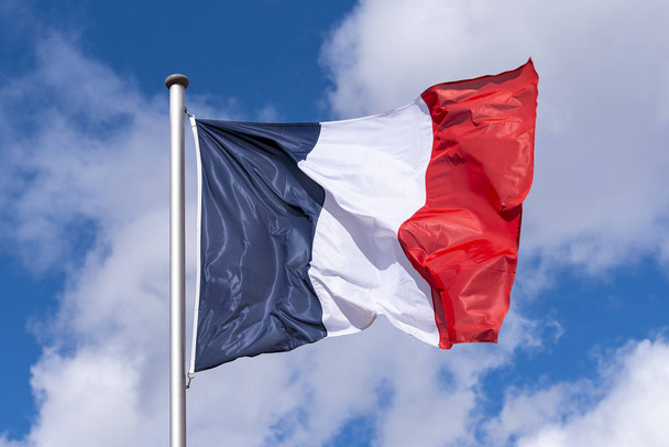 French Flag waving against blue Sky during sunny Day in France - 写真・画像