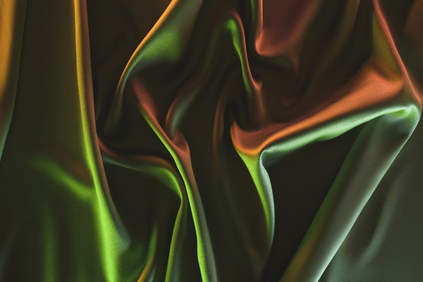 toned picture of elegant folded green silk fabric background - Fotografie, Obrázek