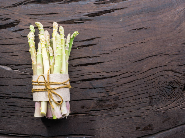 White fresh asparagus sprouts on wooden table. Royal vegetable.  - Photo, Image