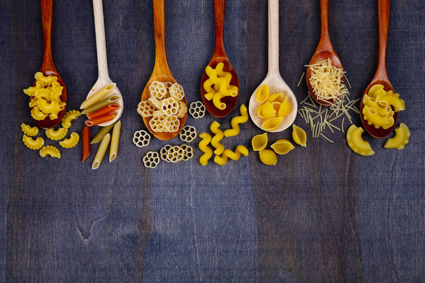 Different pasta in spoons  - Foto, Imagen