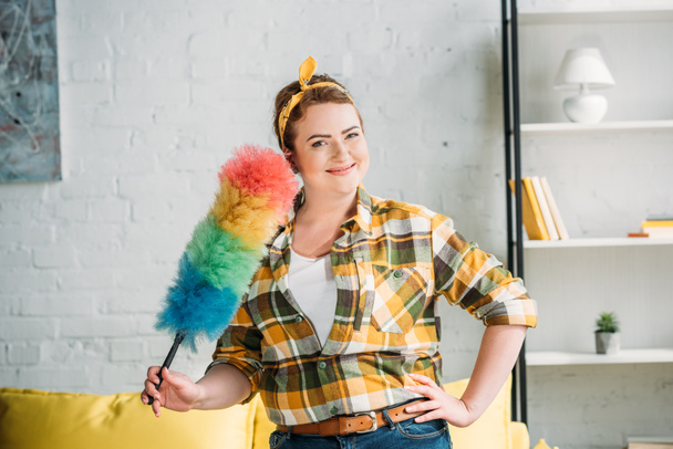 beautiful woman posing with dust brush for cleaning at home - Photo, Image
