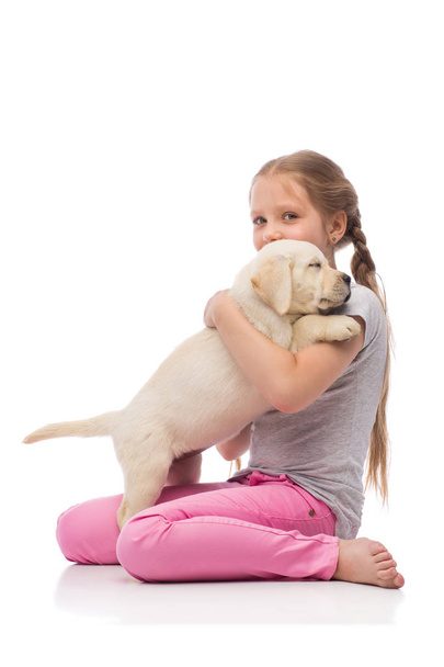 cute Girl with a Labrador puppy - Valokuva, kuva