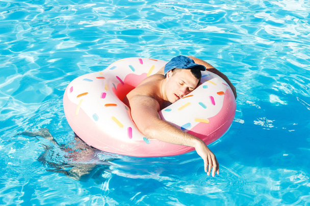 borracho un turista ruso en un donut inflable nadando en la piscina
 - Foto, Imagen