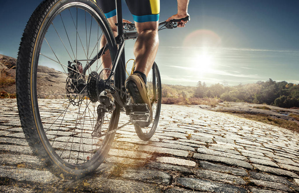 Detail of cyclist man feet riding mountain bike on outdoor trail on country road - Zdjęcie, obraz