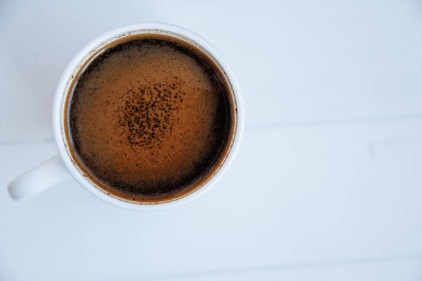 White cup of coffee on white wooden background. Top view. Copy s - Foto, Imagem