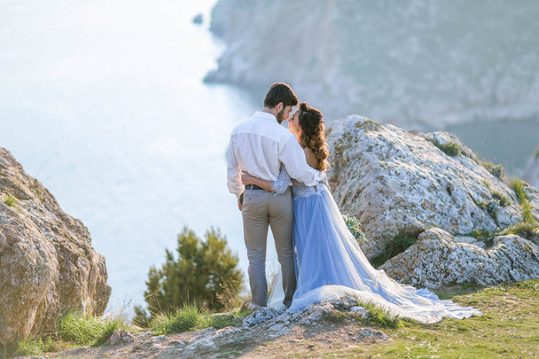 beautiful wedding couple posing against picturesque landscape  - Фото, изображение