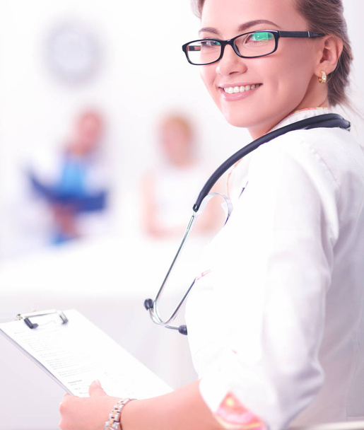 Portrait of woman doctor at hospital with folder - Фото, изображение