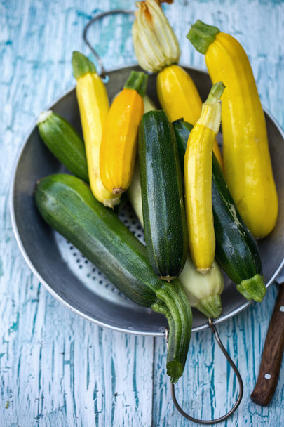 long zucchini in sieve - Фото, изображение