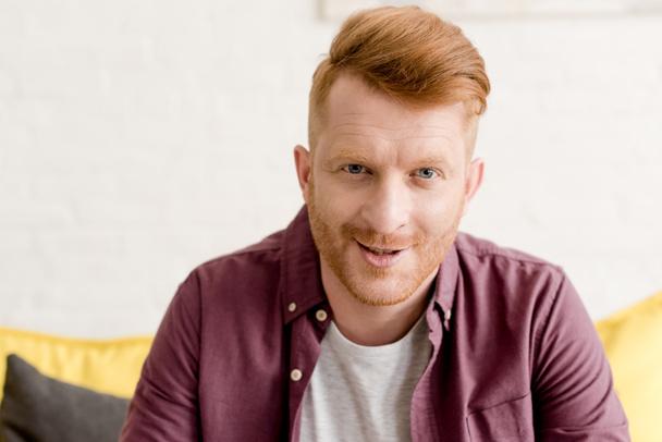 portrait of handsome young redhead man smiling at camera - Photo, Image