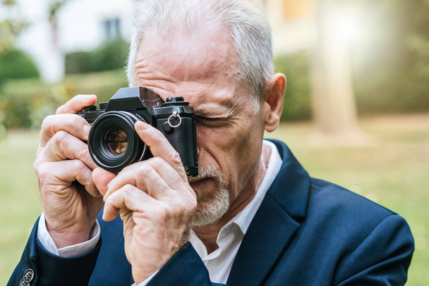 Mature man taking pictures, light effect - Φωτογραφία, εικόνα