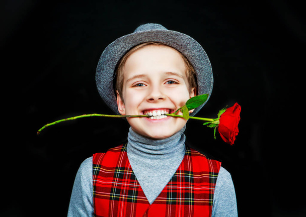 hansome boy   with rose in his teeth  - Фото, изображение