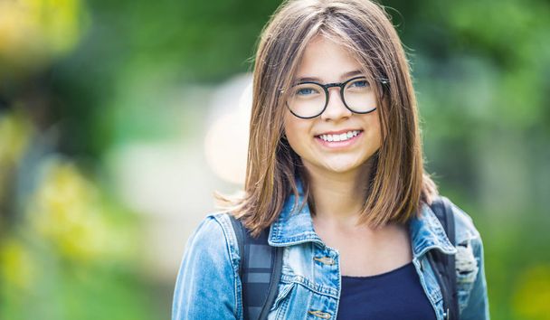 Portrait of attractive young teenage school girl with backpack - Foto, Imagem