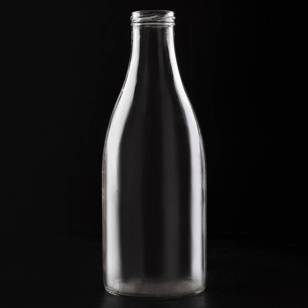 Transparent glass empty bottle jar on a black background - Photo, image
