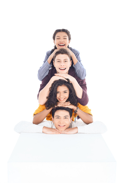 group of teen students lying on each other and looking at camera isolated on white - Photo, Image