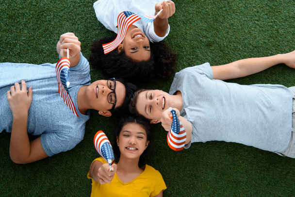 vista superior do grupo de estudantes adolescentes com bandeiras dos EUA na grama verde
 - Foto, Imagem