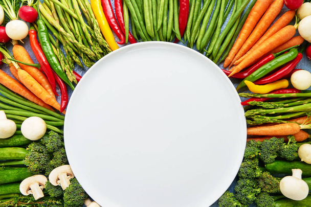 Vegetables background with empty white plate in the middle. Carr - Foto, Imagem