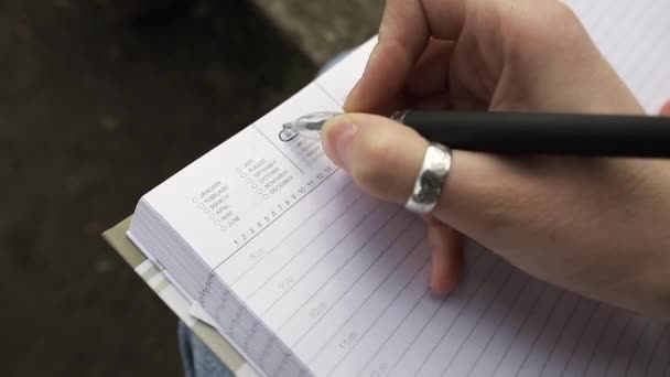 Vacation concept. Close up of notes being taken in a notebook. - Footage, Video