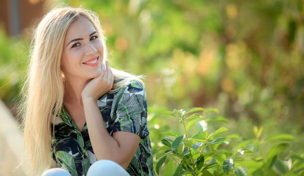 portrait of young beautiful blonde woman , sunflowers on background - Foto, Imagem