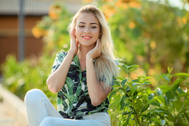 portrait of young beautiful blonde woman , sunflowers on background - Φωτογραφία, εικόνα