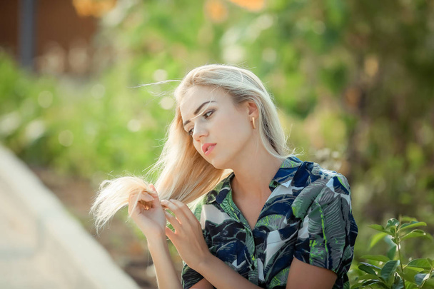 portrait of young beautiful blonde woman , sunflowers on background - Foto, immagini