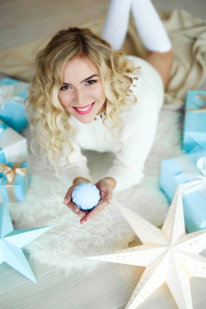   beautiful young blonde woman posing in studio with Christmas decorations  - Photo, image