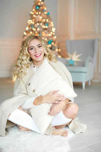 beautiful blonde woman posing in studio with Christmas decor  - Zdjęcie, obraz