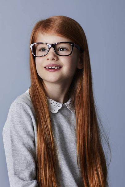 Portrait of smiling redhead girl in glasses, looking away - Valokuva, kuva