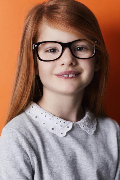 Confident girl in spectacles with red hair smiling at camera, portrait - Foto, Imagem