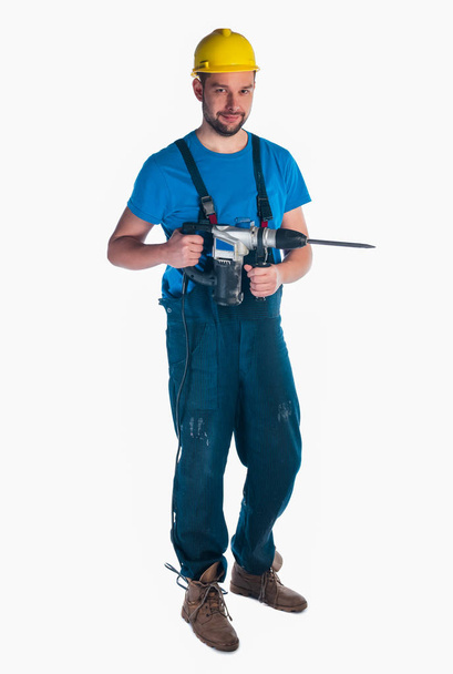 Εργάτης που κρατά ένα τρυπάνι σε λευκό φόντο - Φωτογραφία, εικόνα
