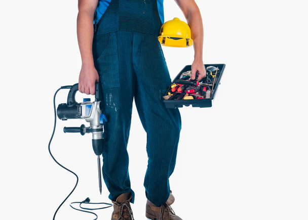 Портрет працівника, який тримає коробку інструментів і свердло
 - Фото, зображення