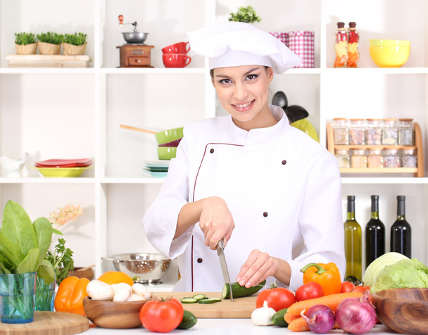 Young woman chef cooking in kitchen - Photo, image