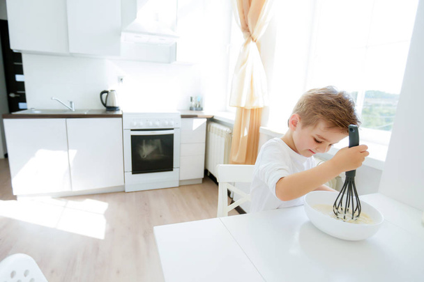 cute little boy on the kitchen posing with kitchen tools  - Fotografie, Obrázek