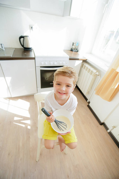 cute little boy on the kitchen posing with kitchen tools  - Φωτογραφία, εικόνα