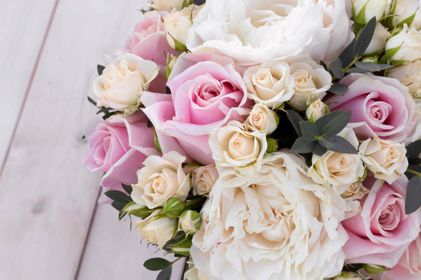 Boeket voor bruid van verschillende bloemen op witte houten achtergrond. Close-up bos van roosjes.  - Foto, afbeelding