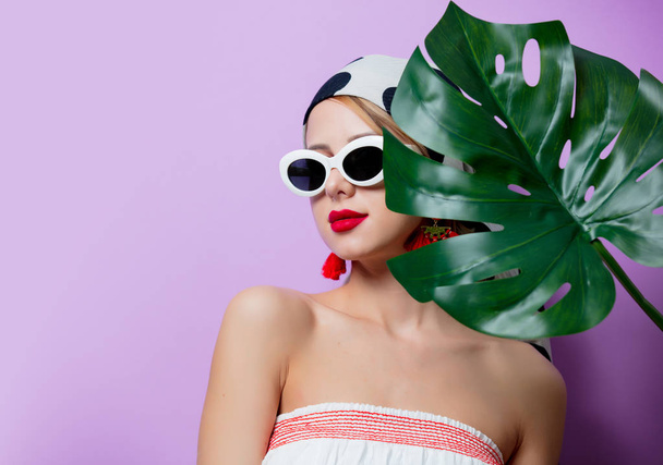 mujer en gafas de sol con hoja de palma
 - Foto, Imagen