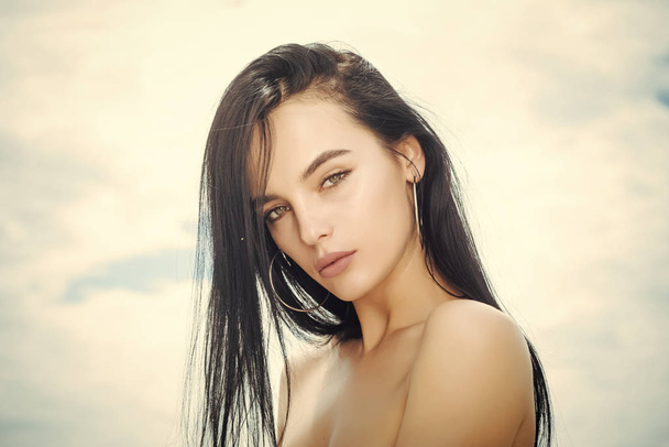 Beautiful woman face over abstract sky background, makeup - Foto, afbeelding