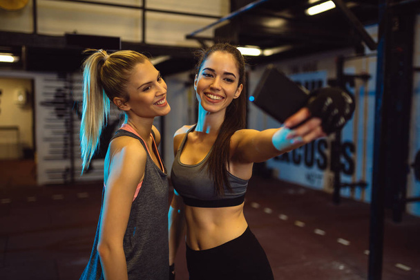 women taking selfie during their training in a gym - Фото, зображення