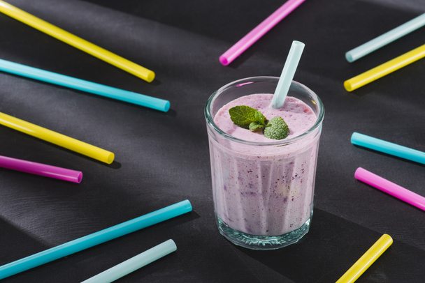 closeup image of drinking straws and glass of berry smoothie with mint  - Foto, immagini